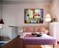 Preview: Sitzecke mit einem hellen Sofa und abstrakten, fröhlichen Motiv im Bilderrahmen