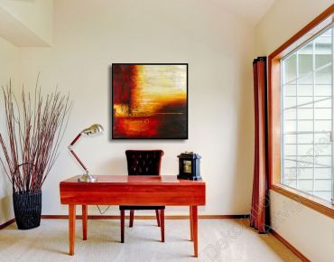 Arbeitszimmer mit einem modernen Ambiente. An der Wamd hängt ein quadratisches, abstraktes Leinwandbild
