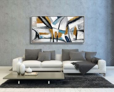 Loftwohnung mit einem abstrakten Bild an einer grauen Wand.