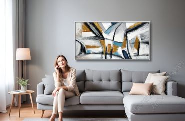 Sitzecke mit vielen warmen Farben. Über dem Sofa hängt ein großes eingerahmtes Bild als Dekoration