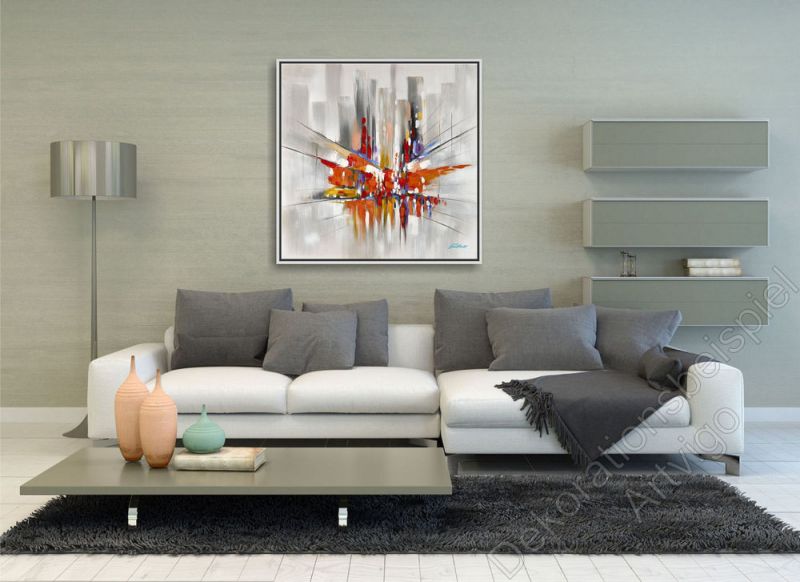 Wohnzimmer mit grauer Wand. Zur Dekoration ein Bild einer abstrakten Stadt im Bilderrahmen